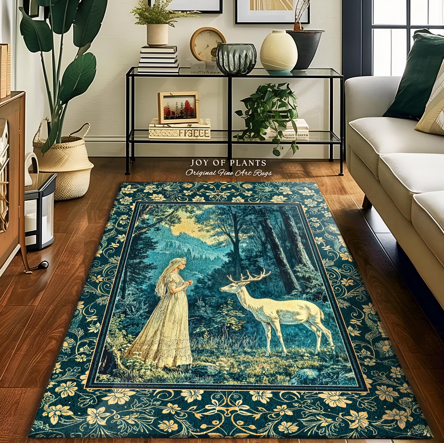 May include: A teal blue rug with a gold border featuring a woman in a white dress standing in a forest with a white deer. The rug has a gold border with floral designs. The text on the rug reads 'Joy of Plants Original Fine Art Rugs'.