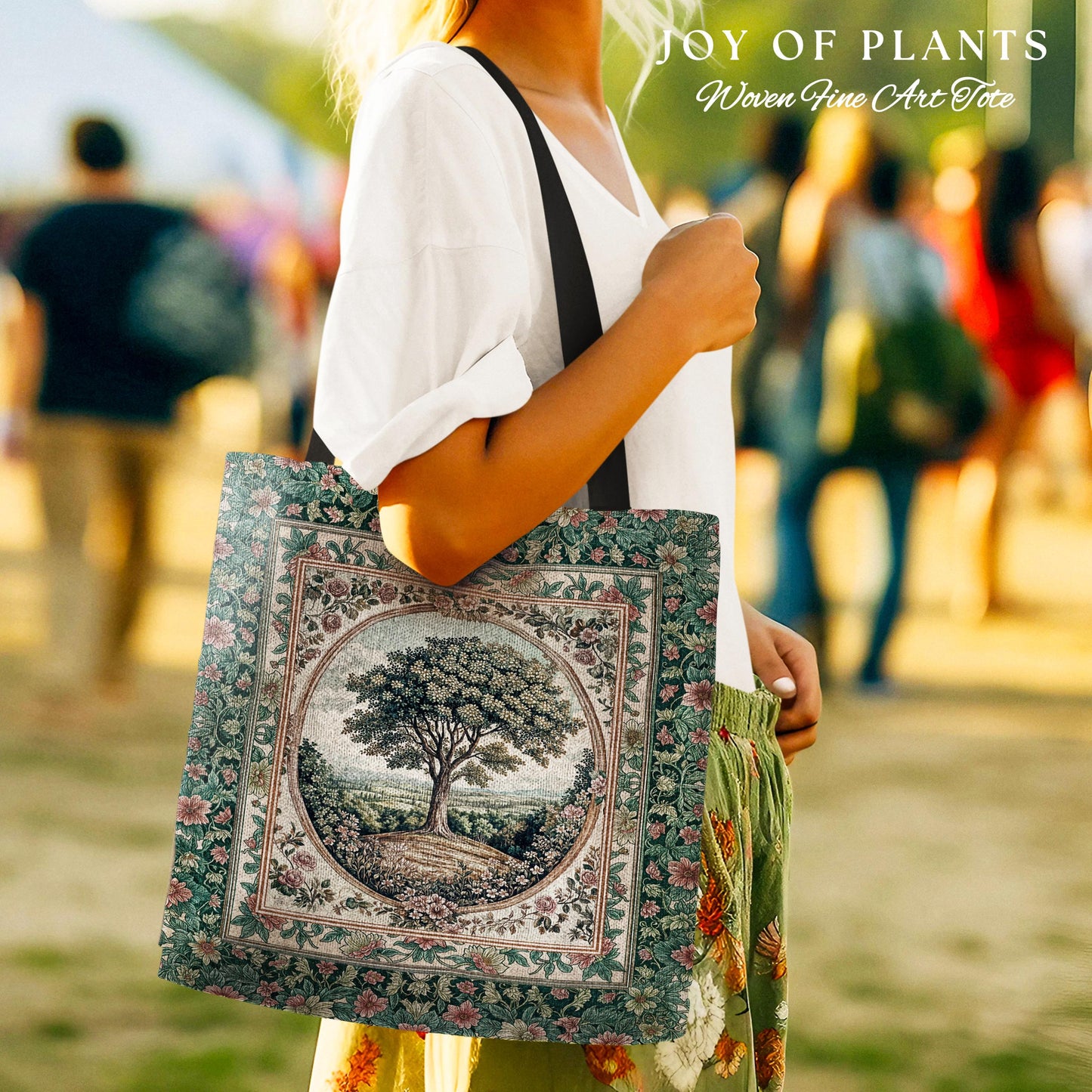 May include: A square tote bag with a tree design. The bag features a detailed illustration of a tree in a circular frame, surrounded by floral patterns. The bag has a green and beige color scheme with a black strap. Text at the top reads 'JOY OF PLANTS' and 'Woven Fine Art Tote'.