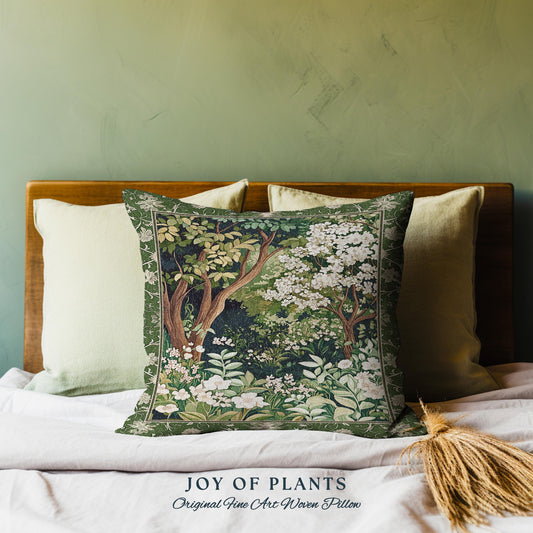 May include: A green and white throw pillow with a tapestry design of trees and flowers. The pillow has the text "JOY OF PLANTS Original Fine Art Woven Pillow" printed on the bottom.