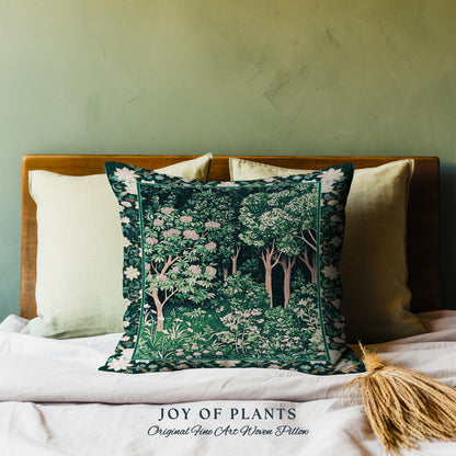 May include: A green and white woven pillow with a floral design. The pillow is on a bed with white linens and a wooden headboard. The text "JOY OF PLANTS Original Fine Art Woven Pillow" is printed below the pillow.