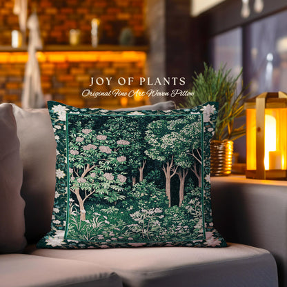 May include: A green and white woven pillow with a floral design. The pillow features a tapestry-like pattern of trees and flowers. The text "JOY OF PLANTS Original Fine Art Woven Pillow" is printed on the pillow.