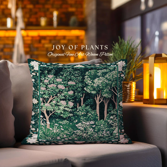May include: A green and white woven pillow with a floral design. The pillow features a tapestry-like pattern of trees and flowers. The text "JOY OF PLANTS Original Fine Art Woven Pillow" is printed on the pillow.