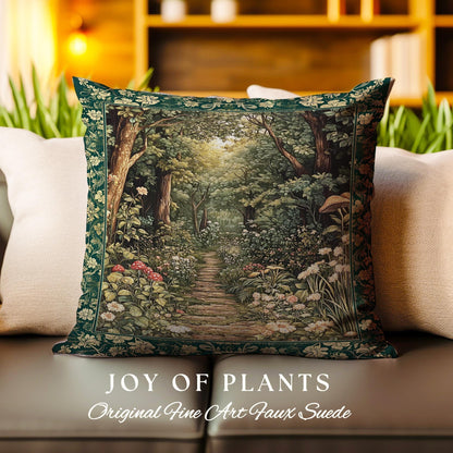 May include: A green throw pillow with a tapestry design of a forest path lined with flowers and trees. The pillow has a border of green leaves and the text "JOY OF PLANTS Original Fine Art Faux Suede" is printed below the pillow.