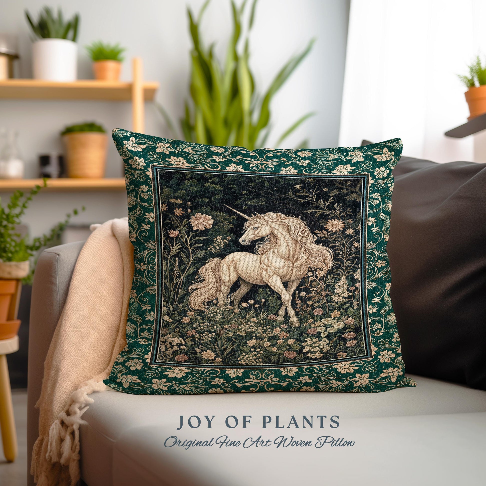 May include: A decorative square pillow with a tapestry design featuring a white unicorn in a floral meadow. The pillow has a dark green border with floral patterns and the text "JOY OF PLANTS Original Fine Art Woven Pillow".