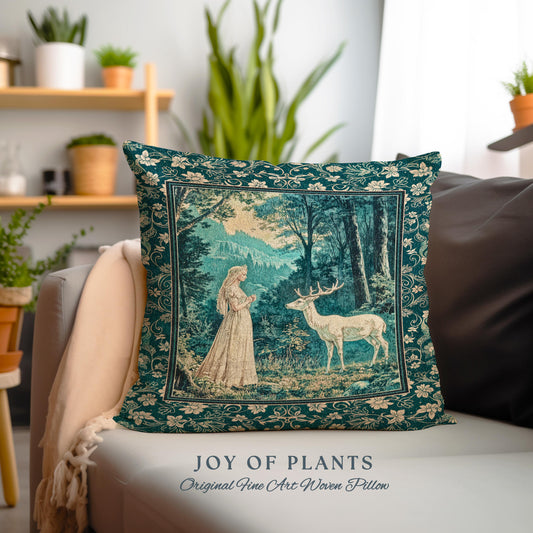 May include: A decorative square pillow with a forest scene featuring a woman and a deer. The pillow has a teal border with floral patterns and the text "JOY OF PLANTS Original Fine Art Woven Pillow".