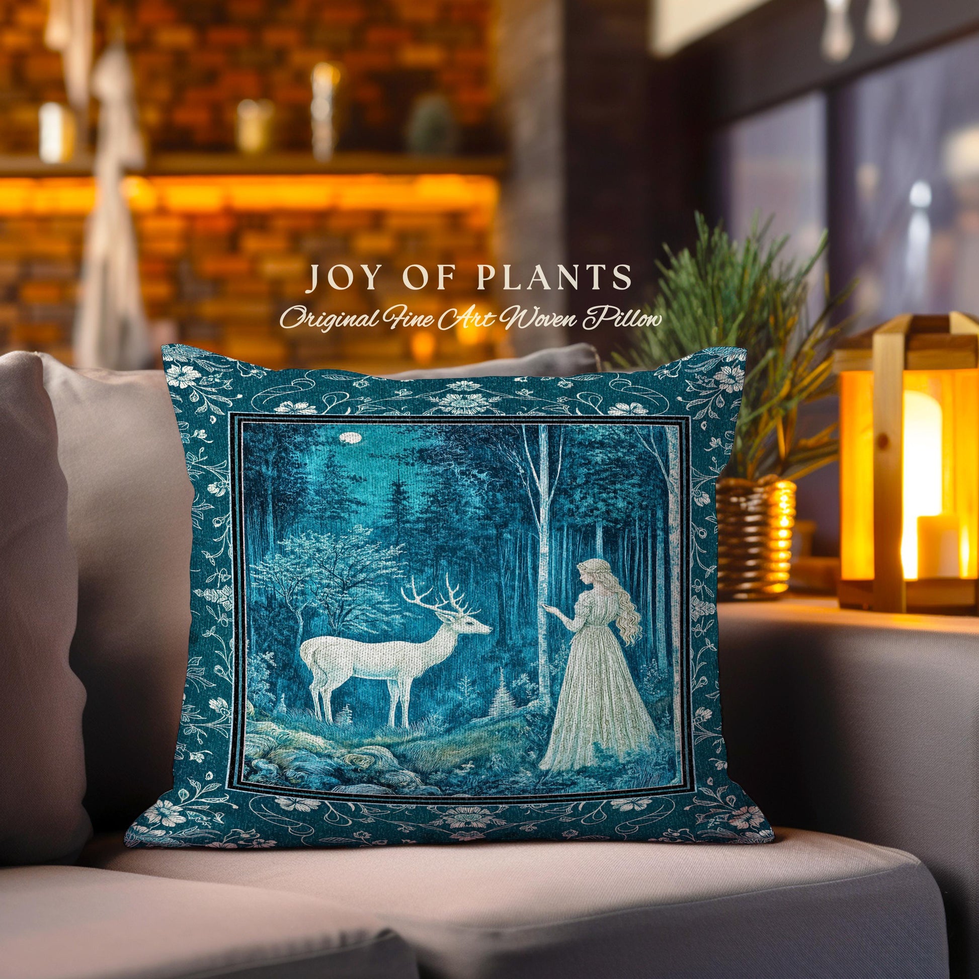 May include: Teal square pillow with a forest scene featuring a white deer and a woman in a long dress. The pillow has a decorative border and the text "JOY OF PLANTS" and "Original Fine Art Woven Pillow".