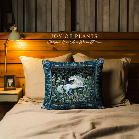 May include: A square pillow with a teal border and a central image of a white unicorn in a forest setting. The pillow is on a bed with tan bedding. The text "JOY OF PLANTS Original Fine Art Woven Pillow" is above the pillow.