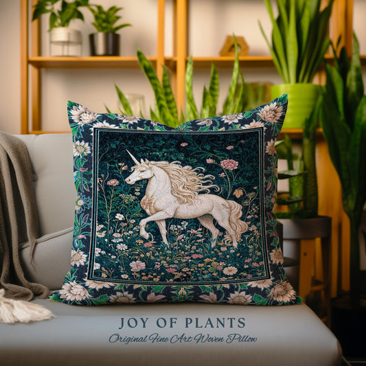 May include: A decorative square pillow featuring a white unicorn with a flowing mane and tail, set against a dark green floral background. The pillow has a floral border and the text "JOY OF PLANTS" and "Original Fine Art Woven Pillow".