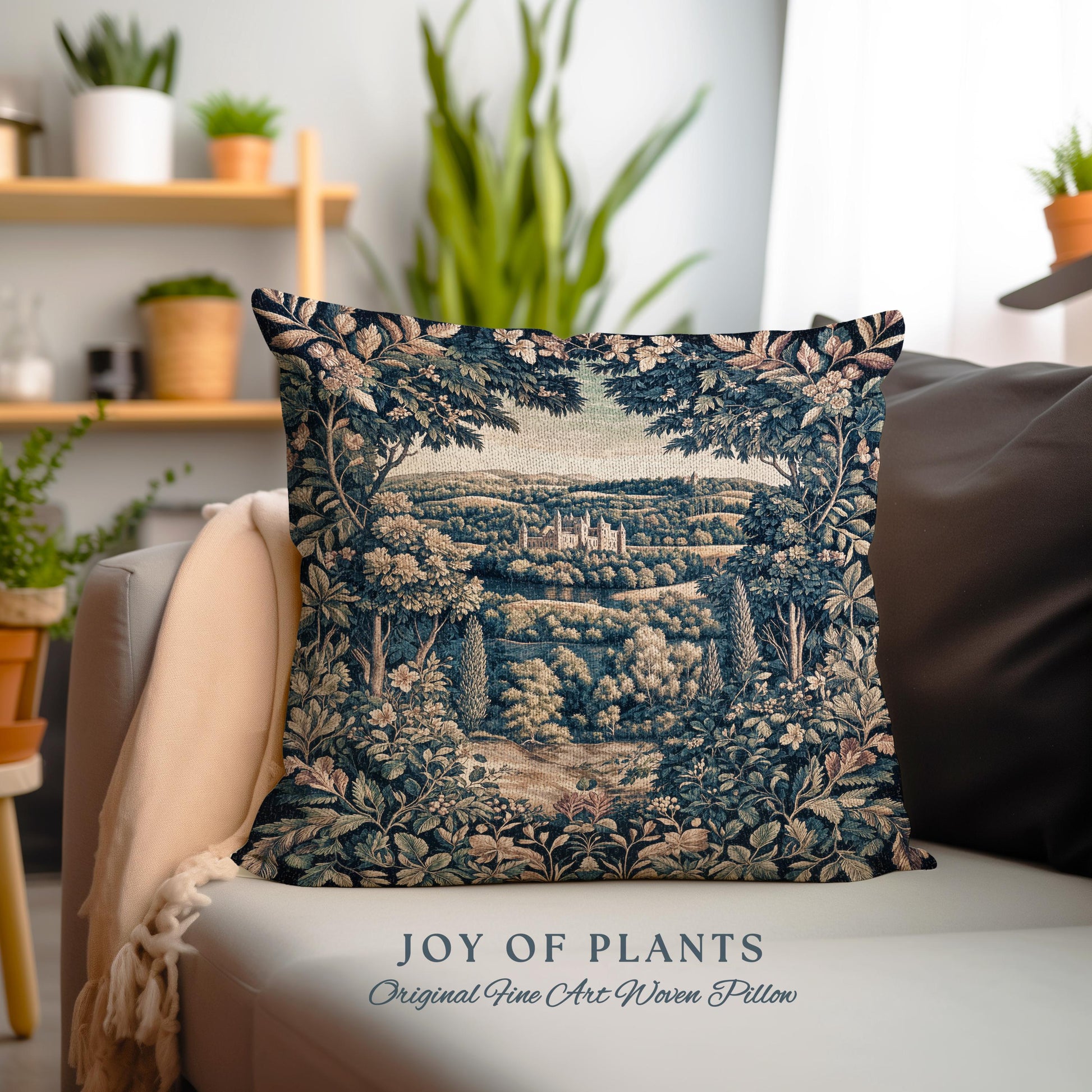 May include: A decorative square pillow with a woven tapestry design. The pillow features a detailed landscape scene with a castle, trees, and foliage in shades of blue, green, and beige. The text "JOY OF PLANTS Original Fine Art Woven Pillow" is at the bottom.