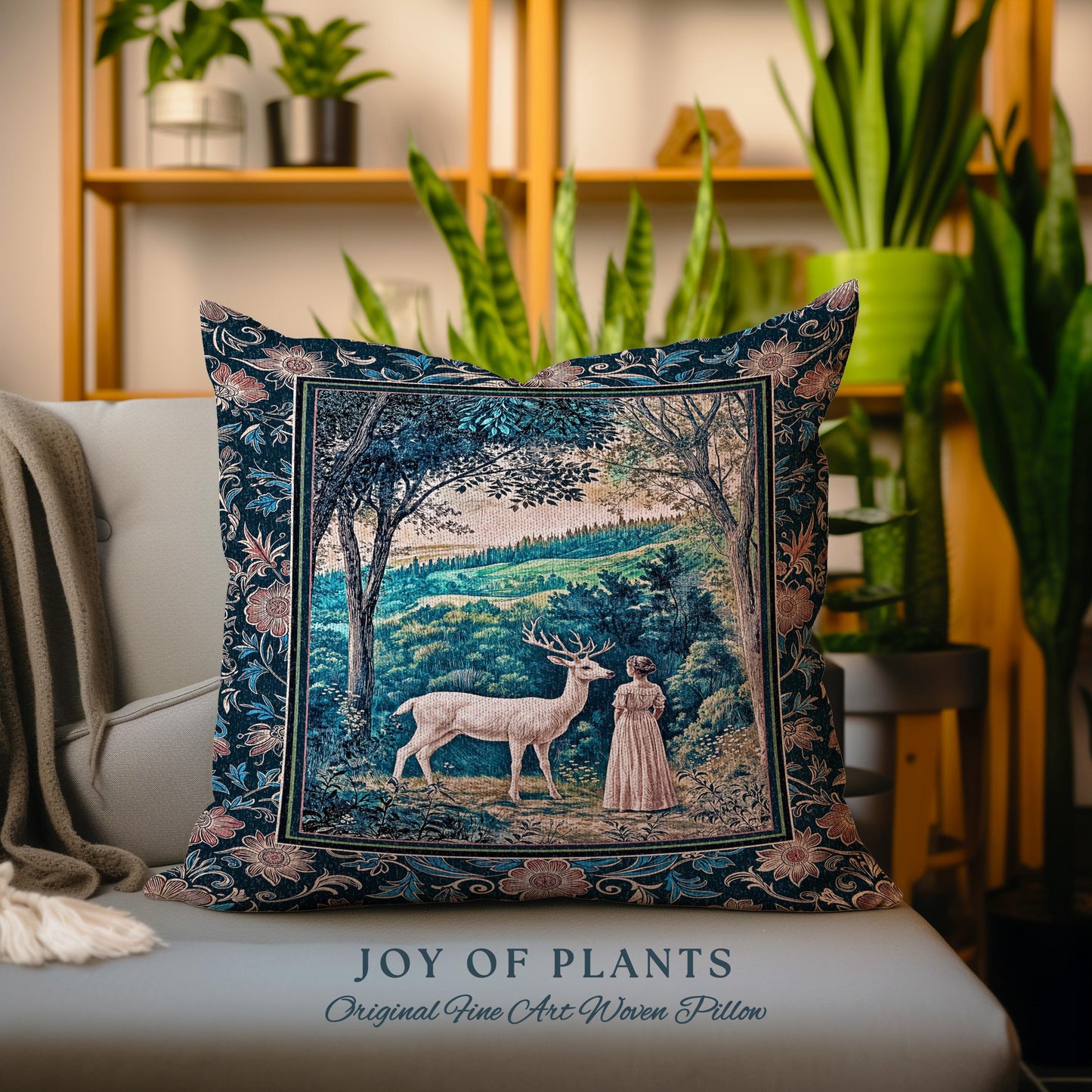 May include: A decorative square pillow with a woven design featuring a deer and a person in a forest scene. The pillow has a dark blue background with floral borders and the text "JOY OF PLANTS" and "Original Fine Art Woven Pillow".