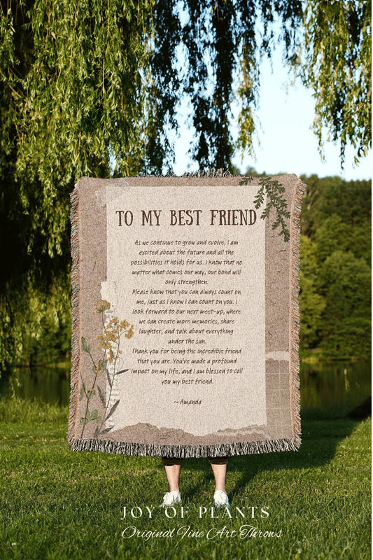 May include: A beige throw blanket with the text "TO MY BEST FRIEND" and a heartfelt message. The blanket has a fringed edge and floral accents. The words "JOY OF PLANTS" and "Original Fine Art Throws" are at the bottom.