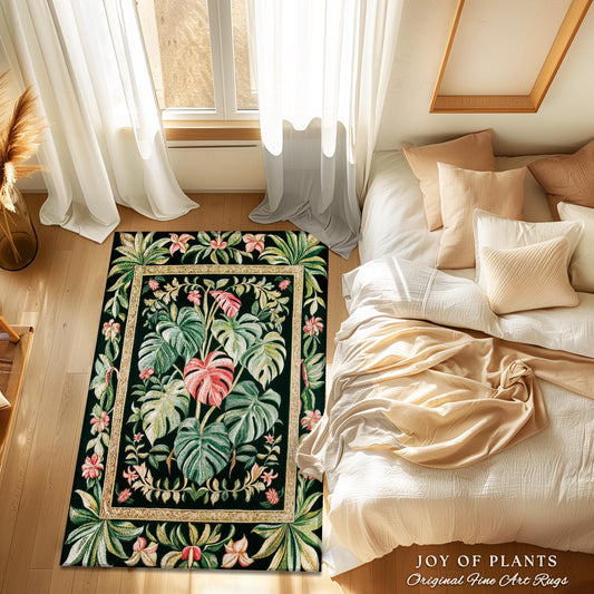 May include: A rectangular area rug with a botanical design featuring large green leaves and pink accents on a black background. The rug has a gold border and is placed on a wooden floor. The text "JOY OF PLANTS Original Fine Art Rugs" is visible.