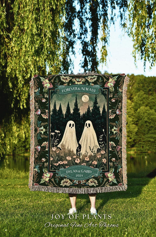 May include: A woven throw blanket featuring a forest scene with two ghost figures, a full moon, and the words "FOREVER & ALWAYS" and "DYLAN & GABBY 2024." The blanket has a dark green background with floral and fringe details. The text "JOY OF PLANTS Original Fine Art Throws" is at the bottom.