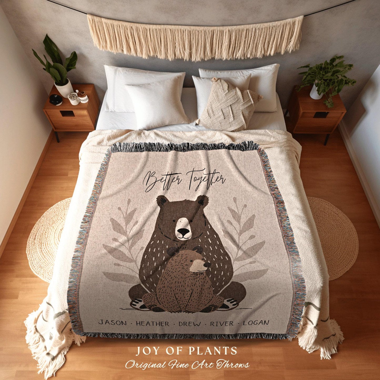 May include: Beige throw blanket with a bear illustration and the text "Better Together." The blanket features a large bear embracing a smaller bear, with names listed below. The bottom of the blanket has the text "JOY OF PLANTS Original Fine Art Throws."