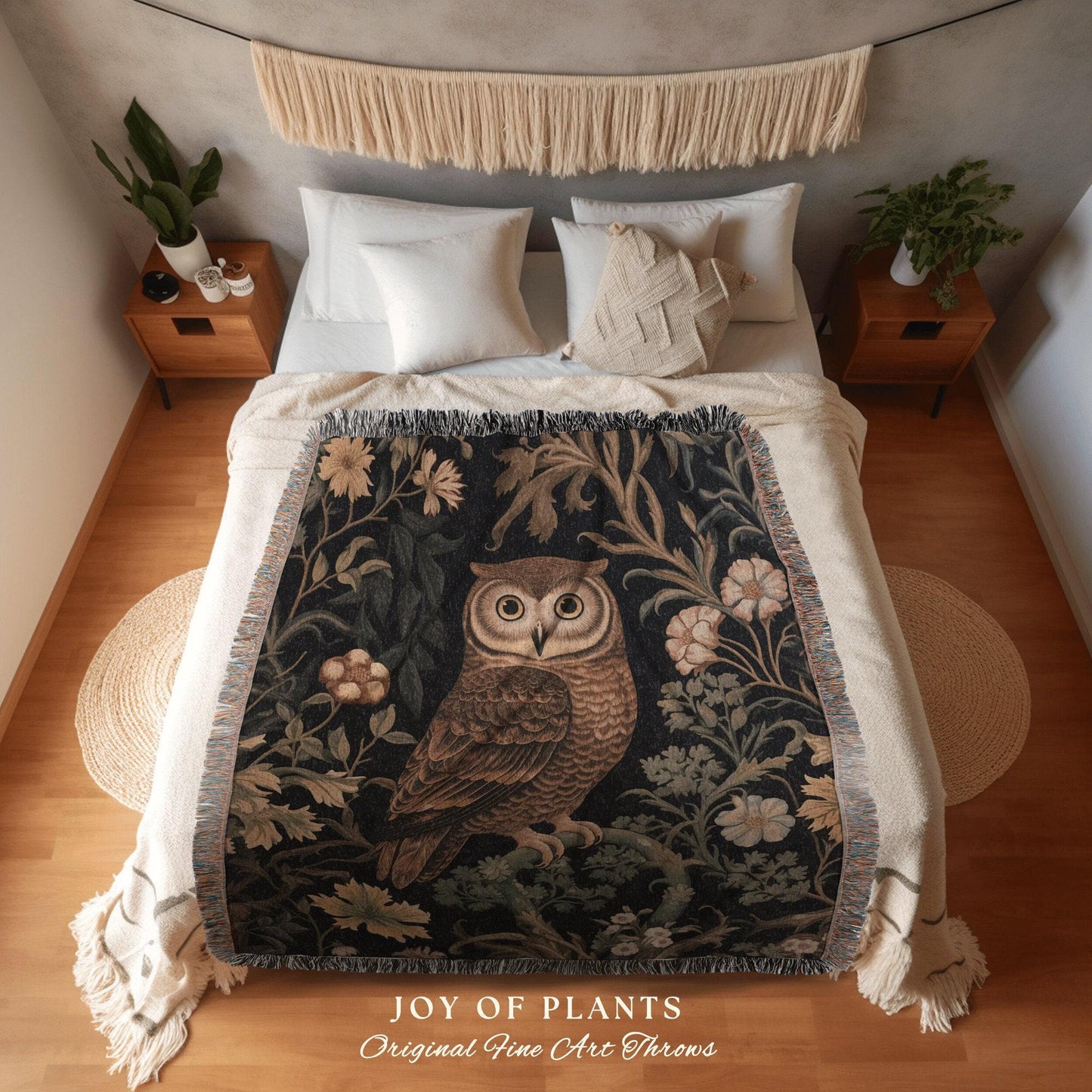 May include: A decorative throw blanket featuring a detailed illustration of an owl perched on a branch, surrounded by floral and foliage elements. The blanket has a dark background with cream-colored fringe and the text "JOY OF PLANTS Original Fine Art Throws".