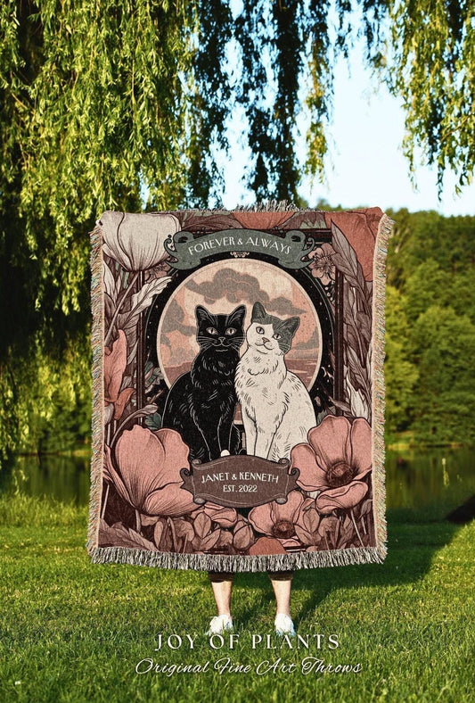 May include: A decorative throw blanket featuring a black and white cat illustration, surrounded by floral elements. The blanket has the text "FOREVER & ALWAYS" and "JANET & KENNETH EST. 2022". The bottom of the blanket reads "JOY OF PLANTS Original Fine Art Throws".