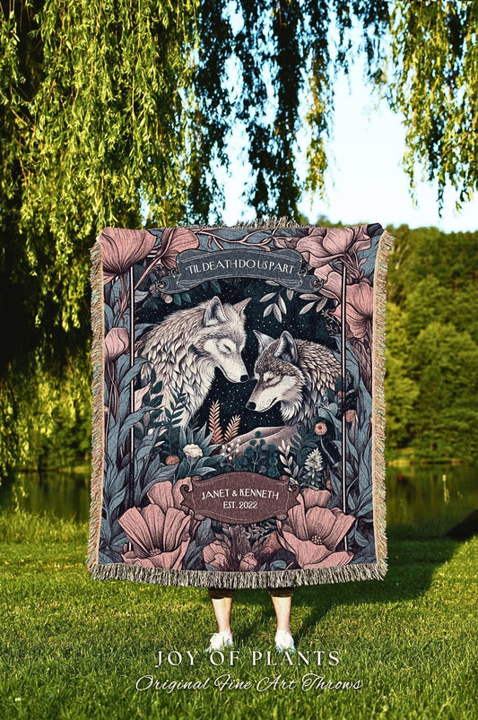 May include: A woven throw blanket featuring a romantic design with two wolves, surrounded by flowers and foliage. The text "TIL DEATH DO US PART" is at the top, with "JANET & KENNETH EST. 2022" at the bottom. The blanket has a fringed edge.