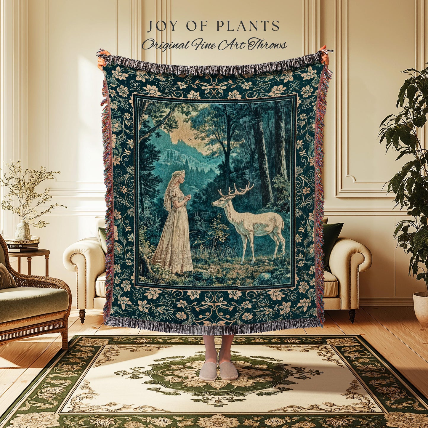 May include: A tapestry throw blanket with a forest scene featuring a woman and a deer. The blanket is dark teal with a floral border and fringe. The text "JOY OF PLANTS Original Fine Art Throws" is at the top.