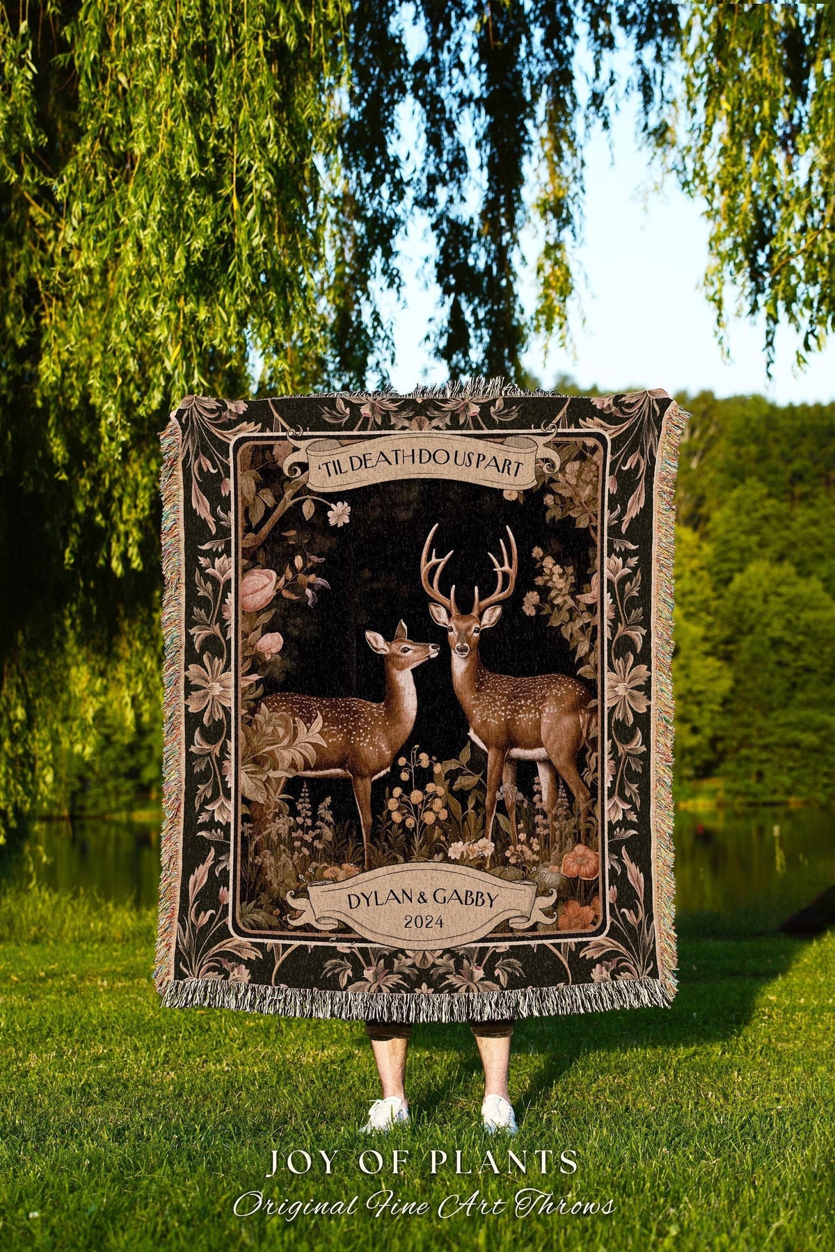 May include: A black woven throw blanket featuring a deer couple illustration with the text "TIL DEATH DO US PART" and "DYLAN & GABBY 2024". The blanket has a decorative floral border and fringe.