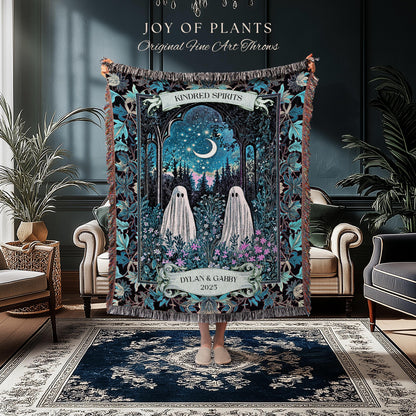 May include: A tapestry throw blanket with a whimsical design featuring two ghost figures in a forest scene under a starry night sky. The blanket has a dark blue and teal color scheme with the text "JOY OF PLANTS" and "Original Fine Art Throws". The text "KINDRED SPIRITS" and "DYLAN & GABBY 2025" are also visible.