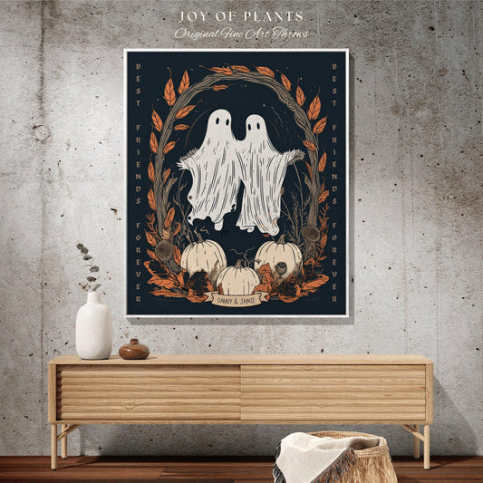 May include: A framed art print featuring two ghost figures with outstretched arms, surrounded by pumpkins and autumn foliage. The text "BEST FRIENDS FOREVER" and "DANNY & JAMIE" are visible. The artwork is set against a dark blue background.