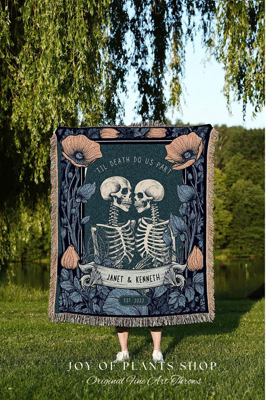 May include: A teal throw blanket featuring a skeleton couple kissing, surrounded by floral elements. The text "TIL DEATH DO US PART" and the names "JANET & KENNETH" are displayed. The blanket has a fringed edge and the year "EST 2022".