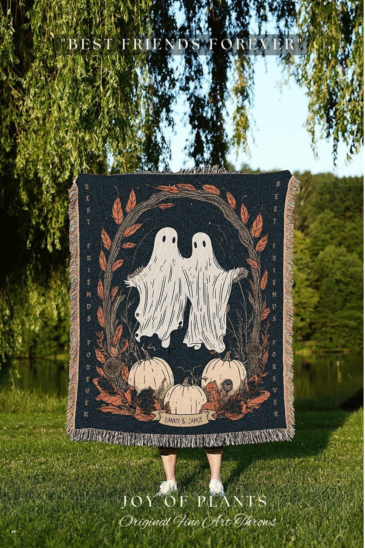 May include: A dark blue throw blanket with a design featuring two white ghost figures, pumpkins, and fall foliage. The words "BEST FRIENDS FOREVER" and "DANNY & JAMIE" are also visible. The blanket is fringed.