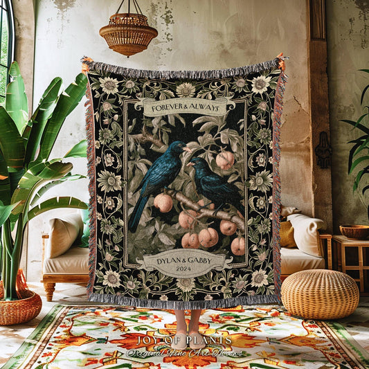 May include: A black woven throw blanket featuring a design with two blue birds perched on a branch with peaches. The words "FOREVER & ALWAYS" and "DYLAN & GABBY 2024" are displayed on the blanket. The blanket has a fringed edge.