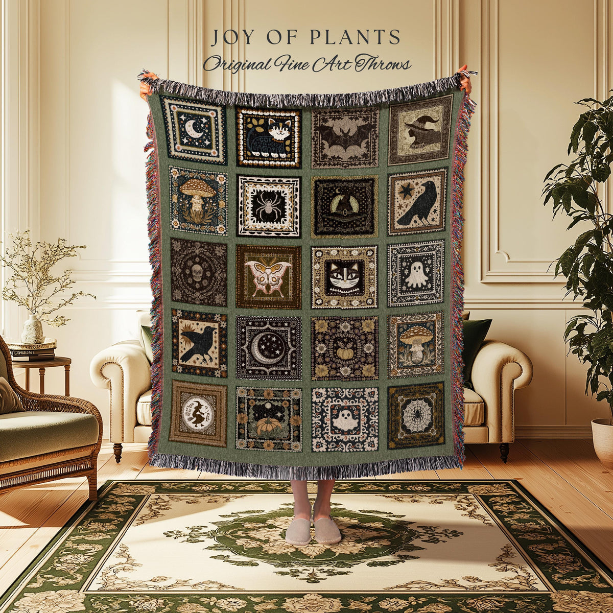 May include: A green throw blanket with a patchwork design featuring various Halloween-themed images, including a cat, bat, and moon. The blanket has a fringed edge and the text "JOY OF PLANTS Original Fine Art Throws".